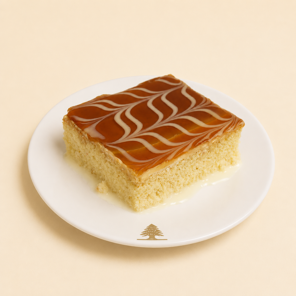 Slice of caramel milk cake with caramel glaze and decorative swirls